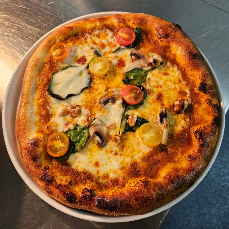 Mushroom, spinach & tomato pizza with truffle oil & candied walnuts